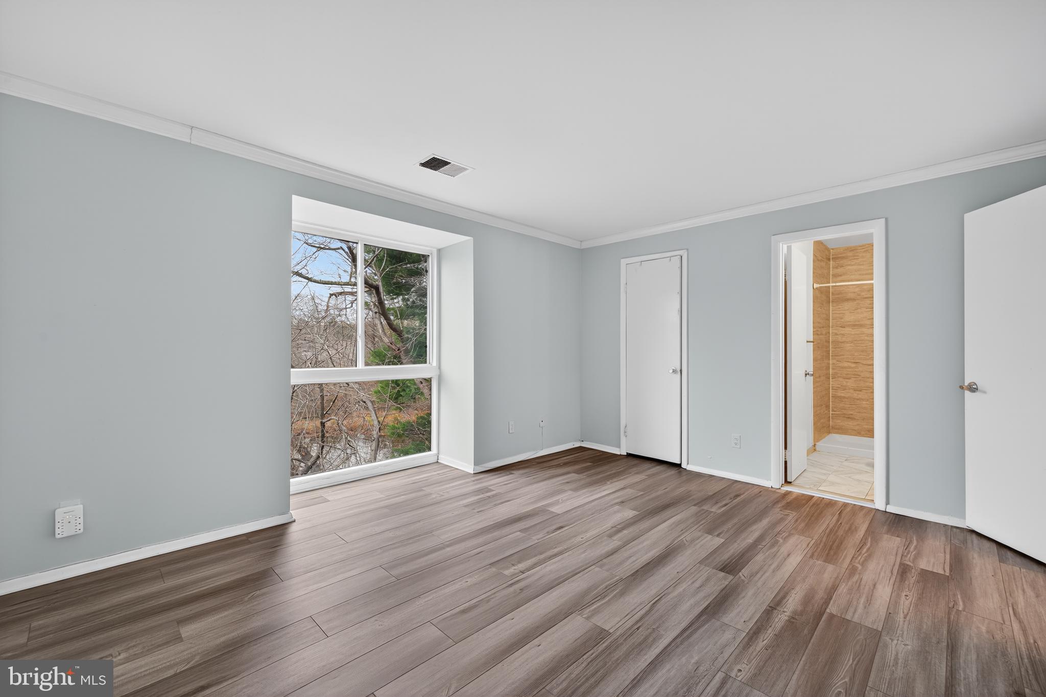 9961 Lake Landing Road Gaithersburg, MD 20886 - Photo 14 of 40 a view of an empty room with wooden floor and a window