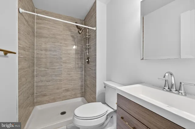 a bathroom with a sink toilet and shower