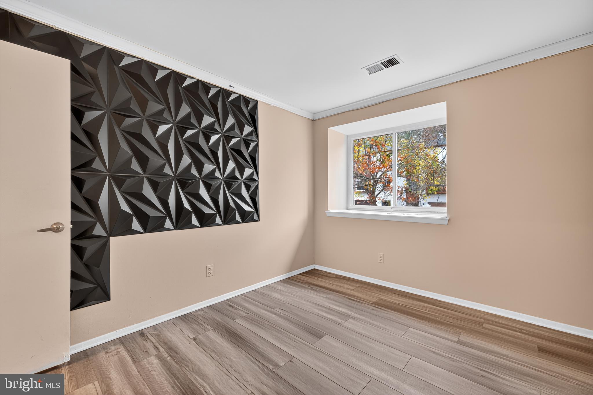9961 Lake Landing Road Gaithersburg, MD 20886 - Photo 18 of 40 a view of an empty room with wooden floor and a window