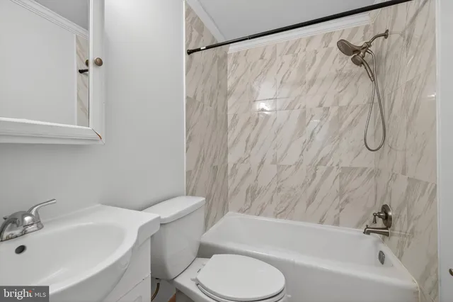 a bathroom with a sink toilet and bathtub