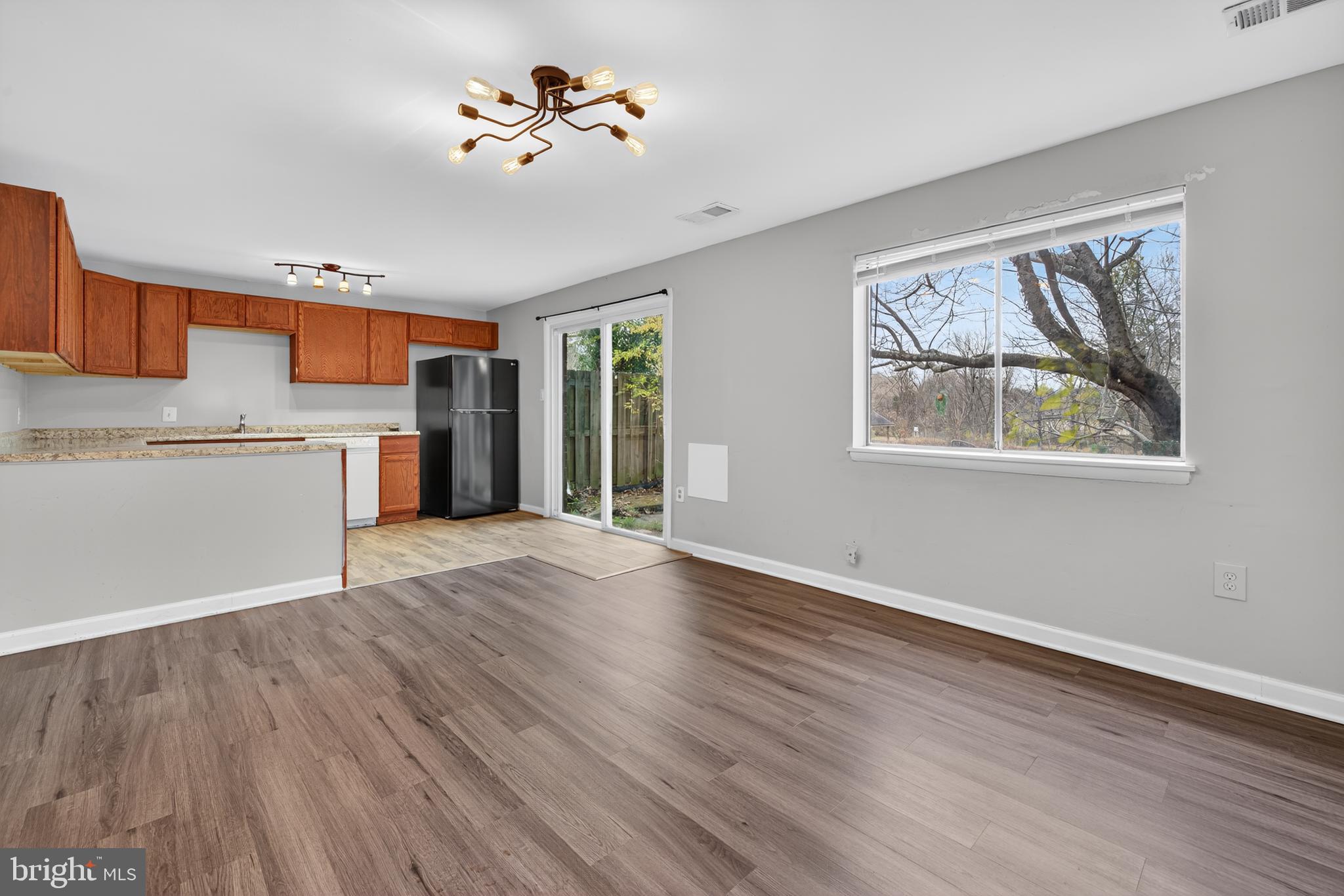 9961 Lake Landing Road Gaithersburg, MD 20886 - Photo 23 of 40 a view of an empty room with a window and wooden floor