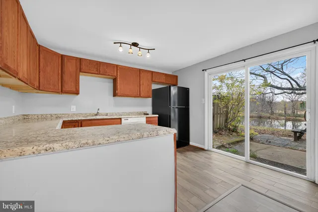 a kitchen with refrigerator and window