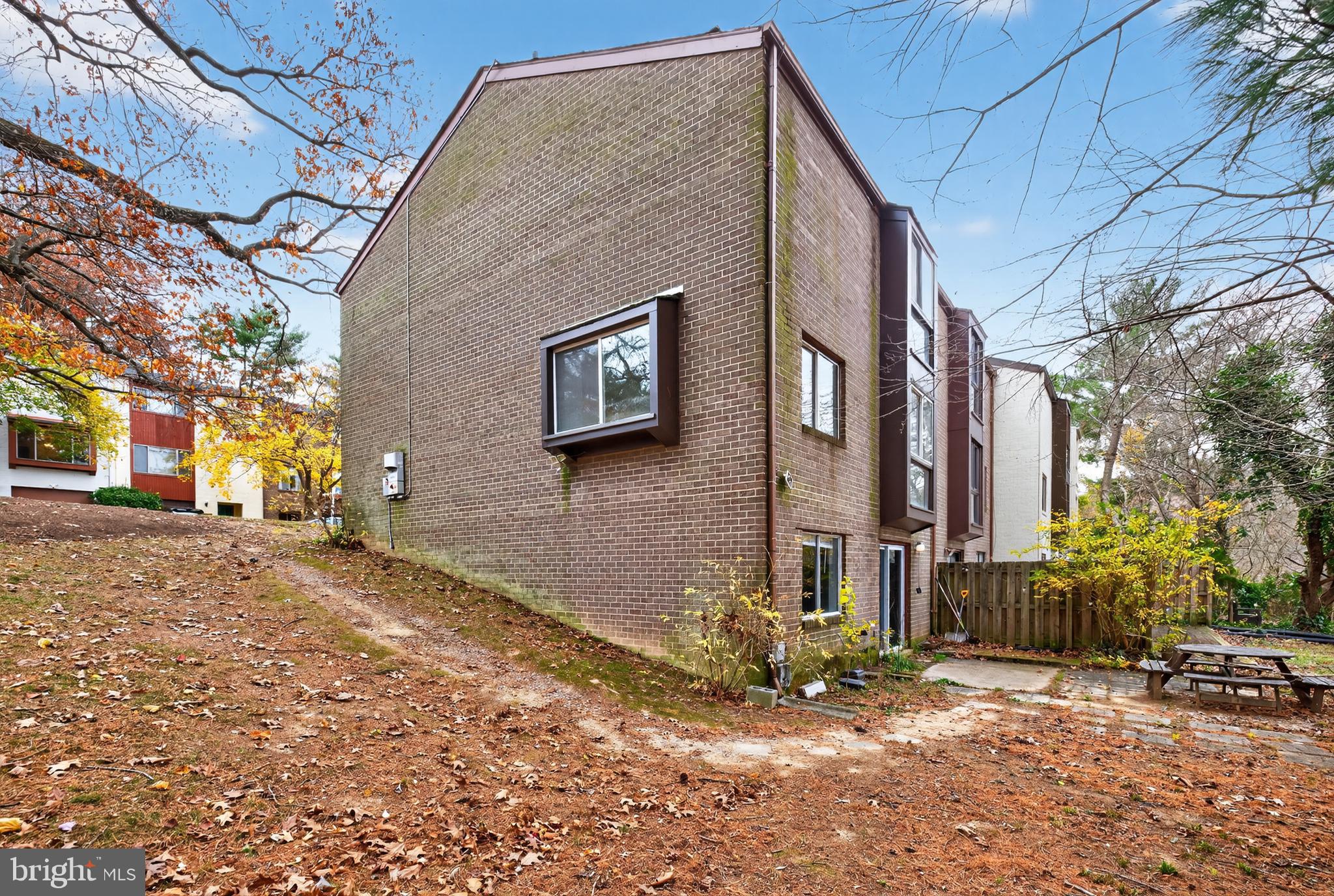 9961 Lake Landing Road Gaithersburg, MD 20886 - Photo 3 of 40 a backyard of a house with large trees and outdoor seating