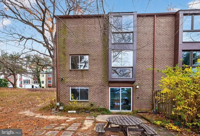 a front view of a building with a garden