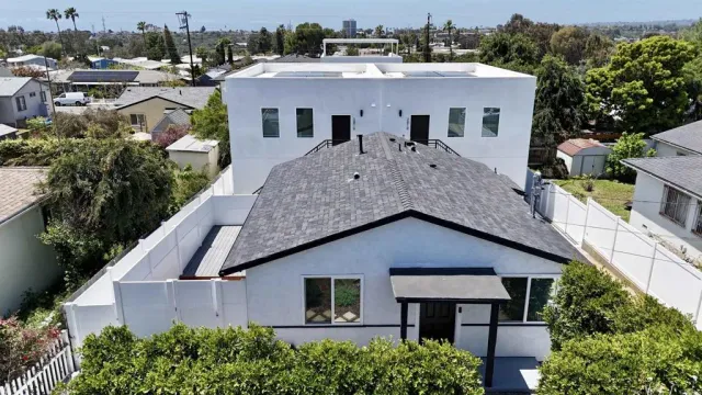 an aerial view of house with yard and green space
