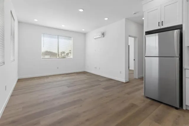 a view of a kitchen with a refrigerator and a window