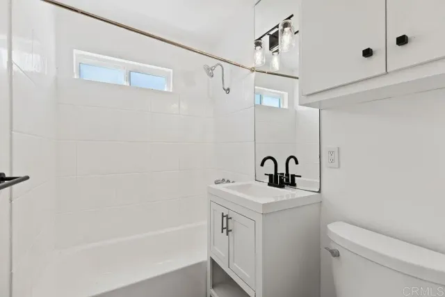 a bathroom with a bathtub a sink a toilet and shower