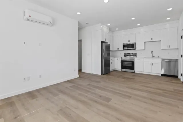 a view of kitchen with refrigerator stove microwave and cabinets