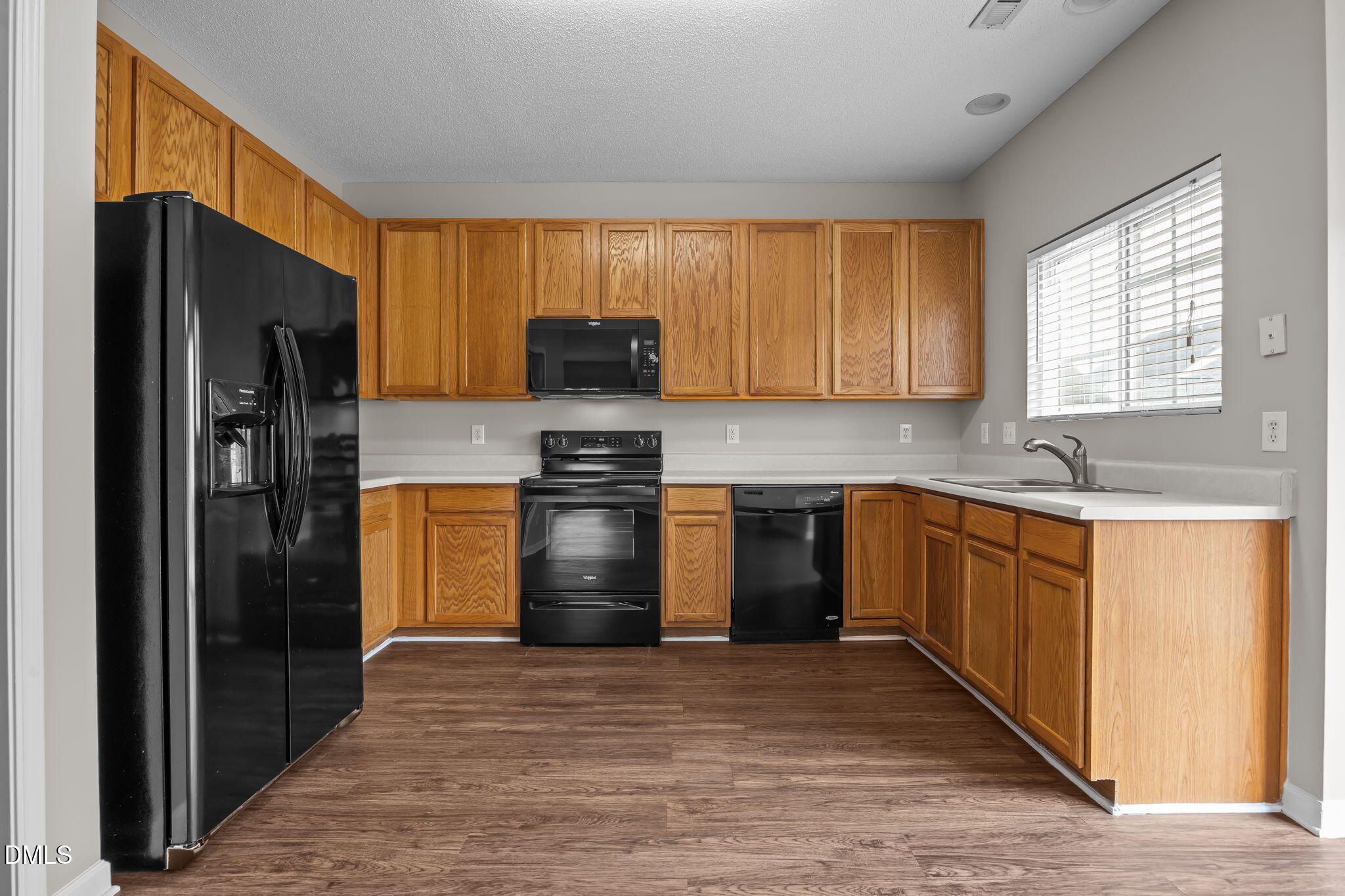 4406 Snowcrest Lane Raleigh, NC 27616 - Photo 12 of 41 a kitchen with a refrigerator and a sink