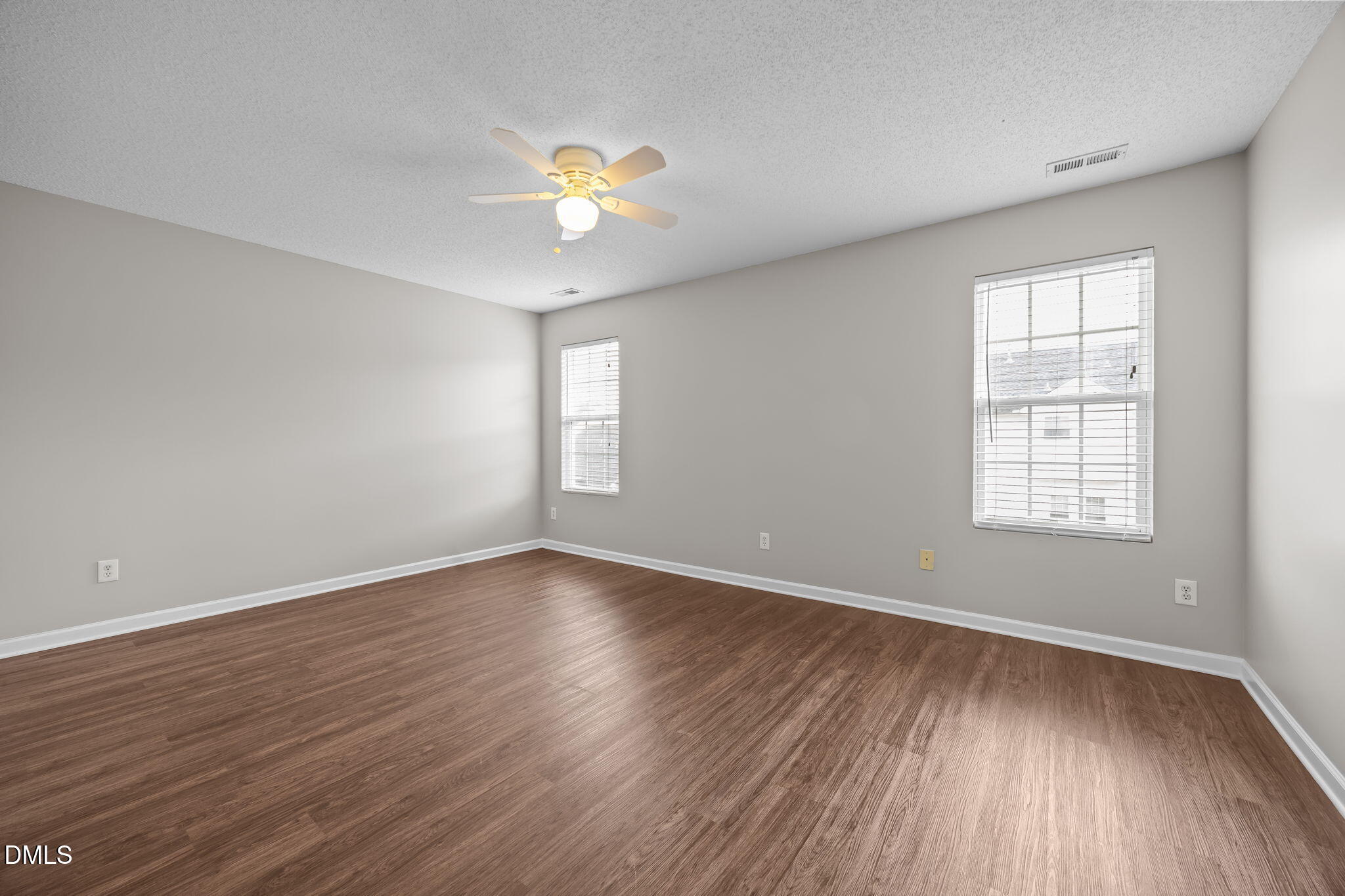 4406 Snowcrest Lane Raleigh, NC 27616 - Photo 16 of 41 an empty room with wooden floor and windows