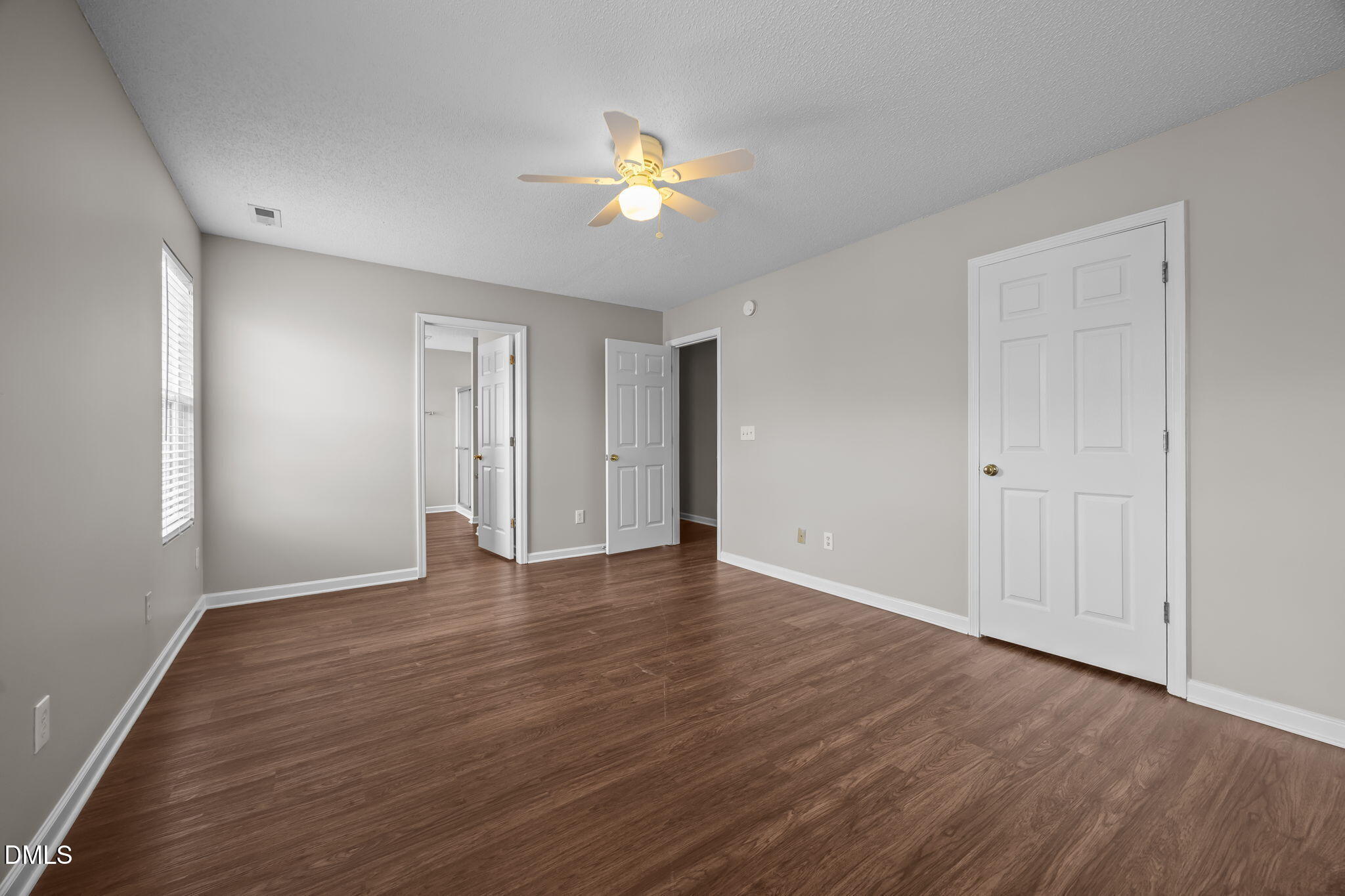 4406 Snowcrest Lane Raleigh, NC 27616 - Photo 17 of 41 a view of an empty room with wooden floor and a window