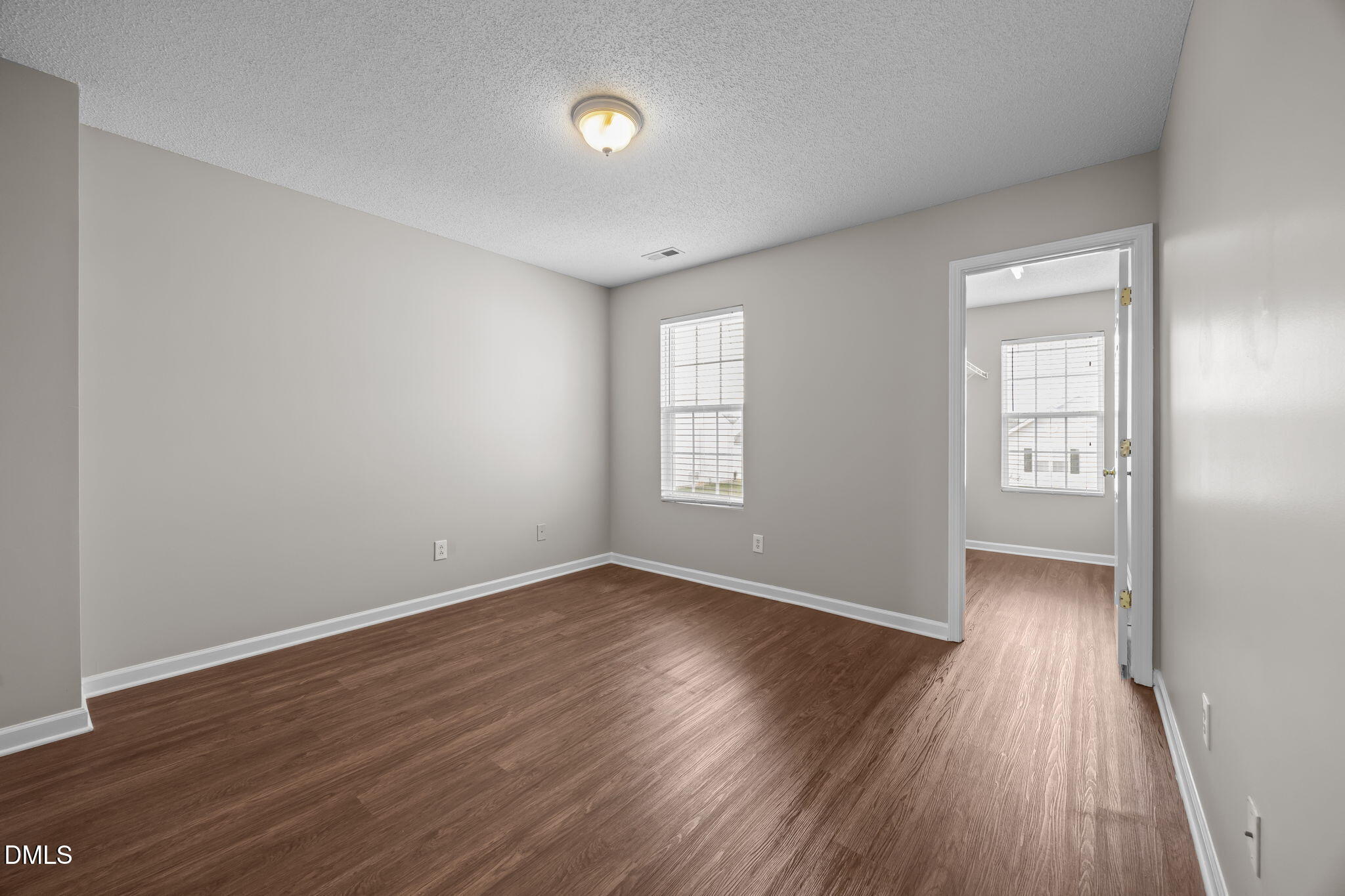 4406 Snowcrest Lane Raleigh, NC 27616 - Photo 23 of 41 an empty room with wooden floor and windows