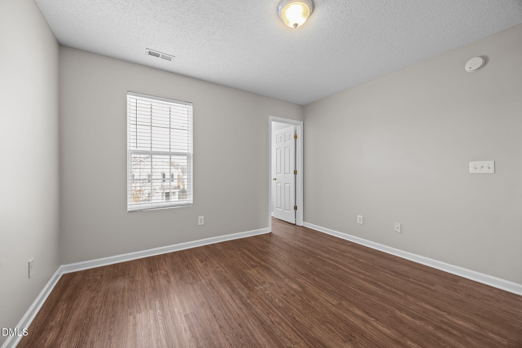 4406 Snowcrest Lane Raleigh, NC 27616 - Photo 24 of 41 an empty room with wooden floor and windows