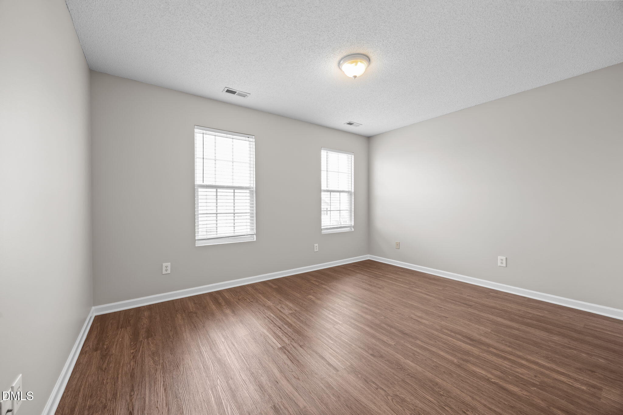 4406 Snowcrest Lane Raleigh, NC 27616 - Photo 27 of 41 an empty room with wooden floor and windows