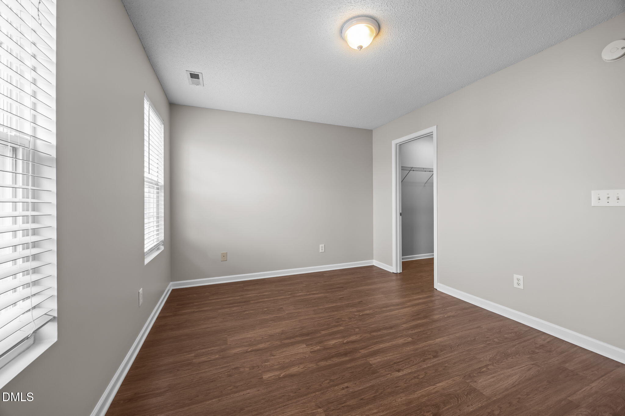 4406 Snowcrest Lane Raleigh, NC 27616 - Photo 28 of 41 an empty room with wooden floor and windows