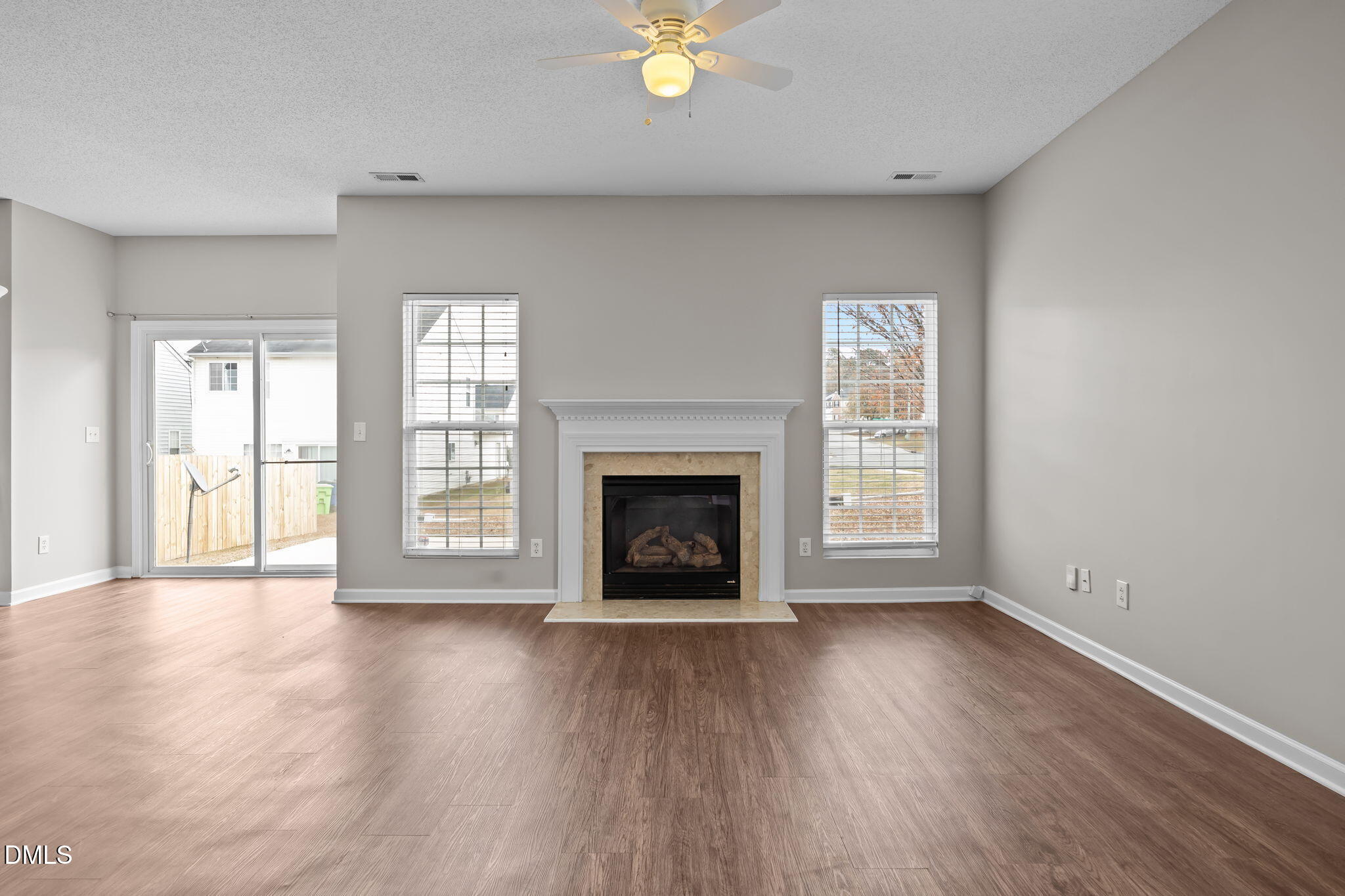 4406 Snowcrest Lane Raleigh, NC 27616 - Photo 8 of 41 wooden floor fireplace and windows in an empty room