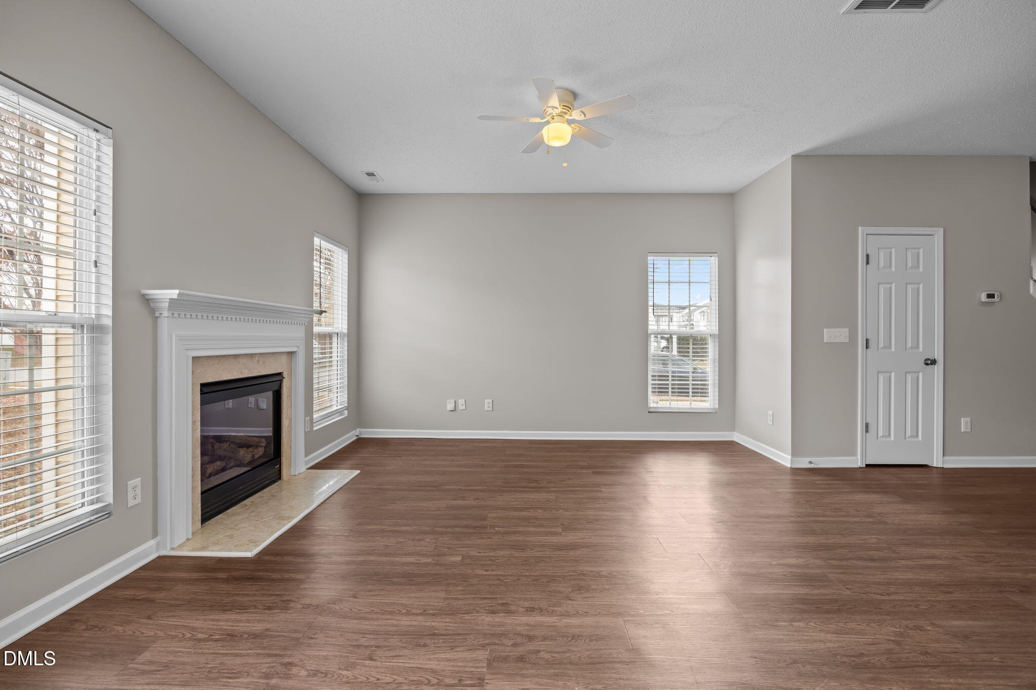 4406 Snowcrest Lane Raleigh, NC 27616 - Photo 9 of 41 an empty room with windows and fireplace