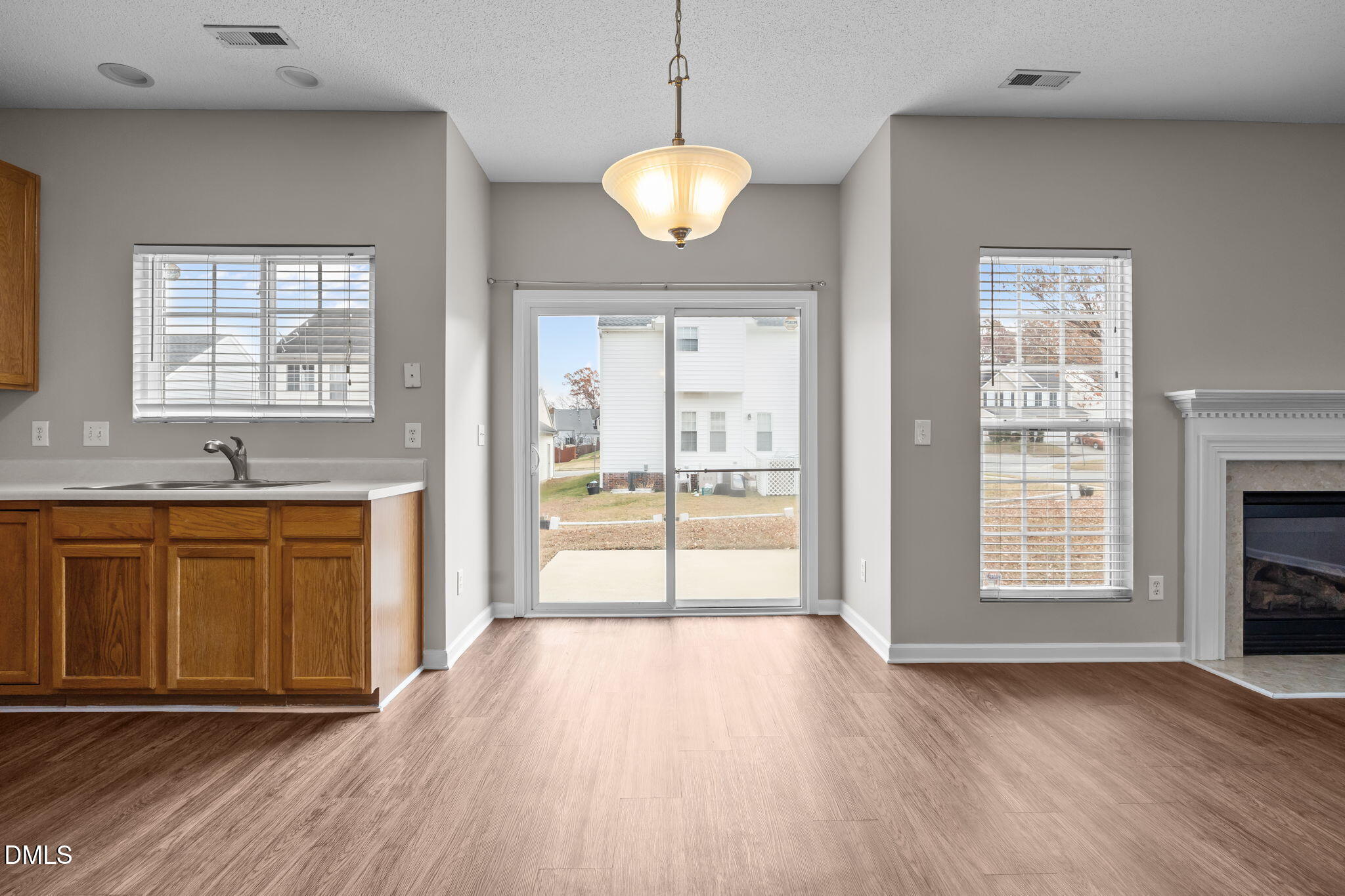 4406 Snowcrest Lane Raleigh, NC 27616 - Photo 10 of 41 a view of an empty room with window and wooden floor