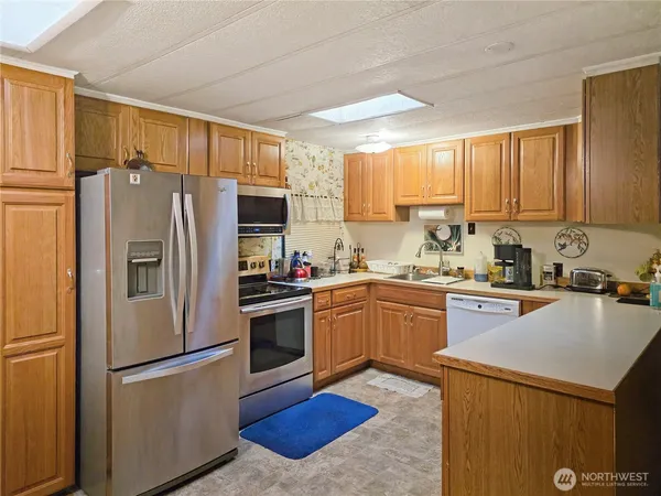 a kitchen with a refrigerator sink and microwave