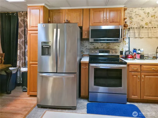 a kitchen with stainless steel appliances a refrigerator stove and microwave