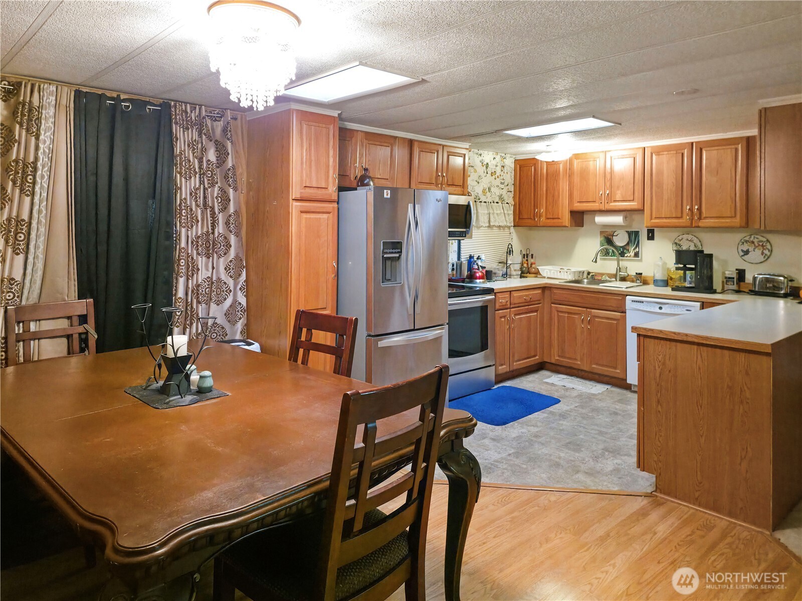 201 Union Avenue Southeast, Unit 192 Renton, WA 98059 - Photo 5 of 8 a kitchen with stainless steel appliances granite countertop a stove refrigerator and cabinets