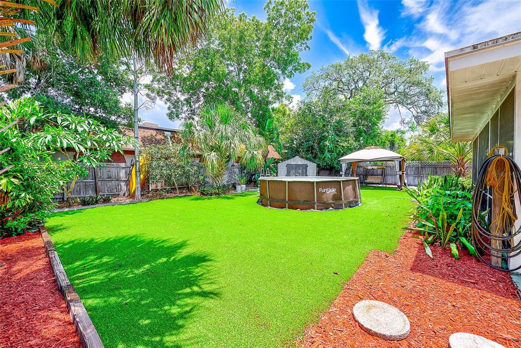 14079 Victoria Road Largo, FL 33774 - Photo 33 of 46 a view of a backyard with plants and a garden