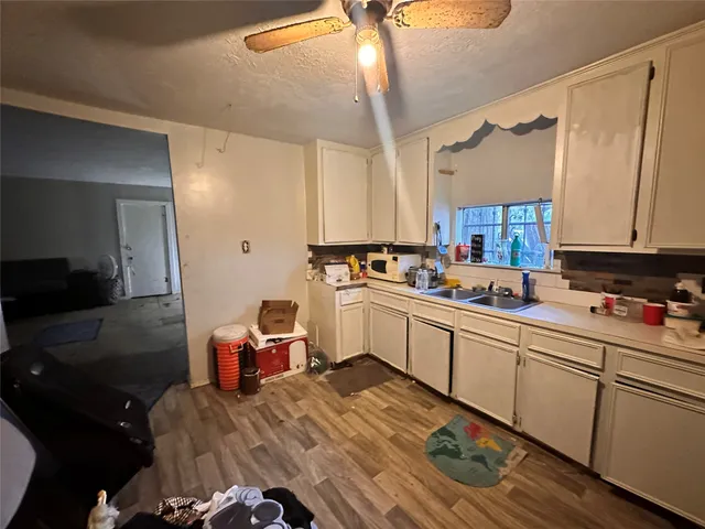 a kitchen with a sink appliances and cabinets