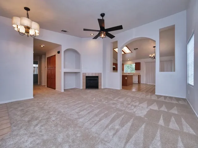 a view of kitchen with granite countertop cabinets and window