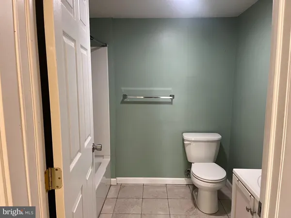 a white toilet sitting next to a shower