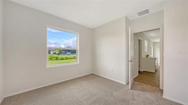 an empty room with windows and closet