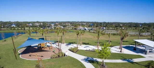 an aerial view of a house with outdoor space lake view and mountain view in back