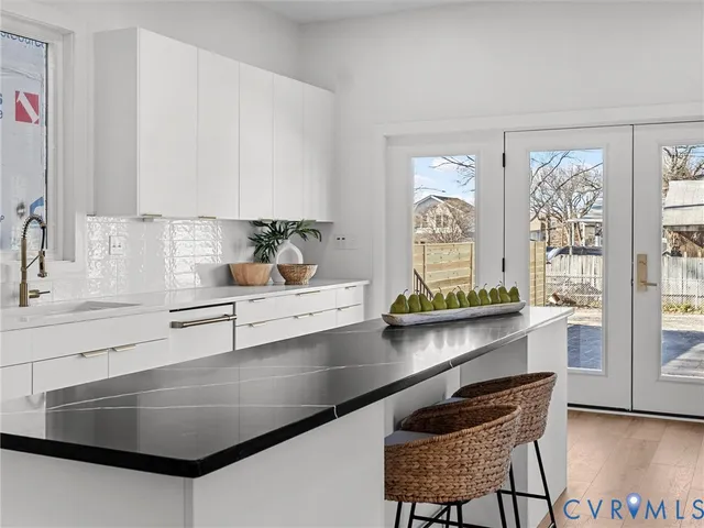a kitchen with a sink appliances and a counter top space