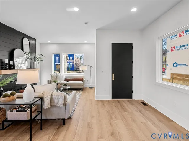 a living room with furniture and wooden floor