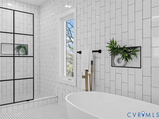 a bathroom with a bathtub and shower
