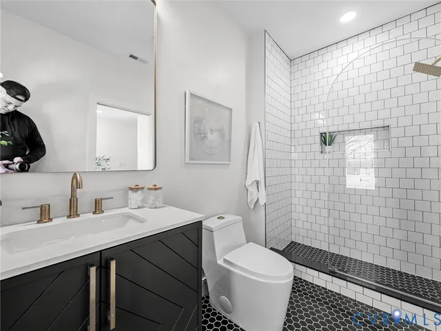 a spacious bedroom with a bed and a chandelier