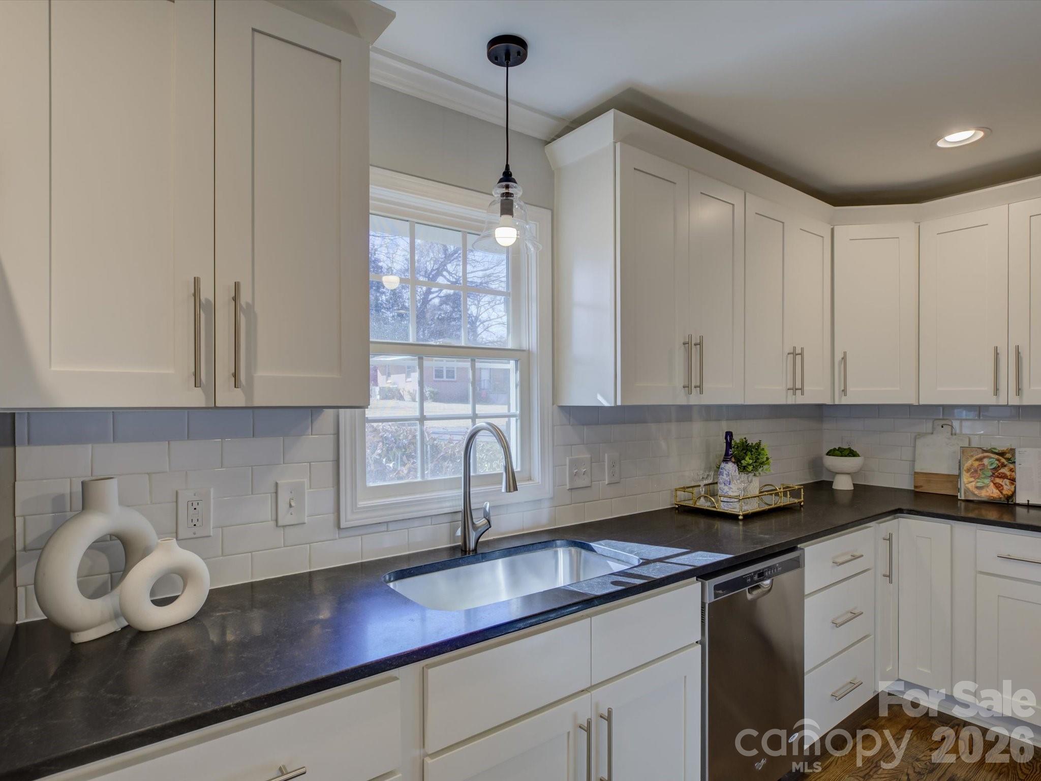 204 West Elliott Street Fort Mill, SC 29715 - Photo 11 of 43 a kitchen with a sink window and cabinets