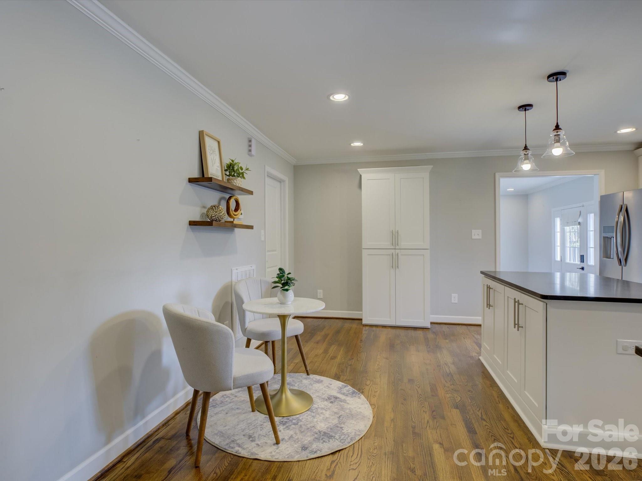 204 West Elliott Street Fort Mill, SC 29715 - Photo 15 of 43 a living room with kitchen island furniture and a chandelier