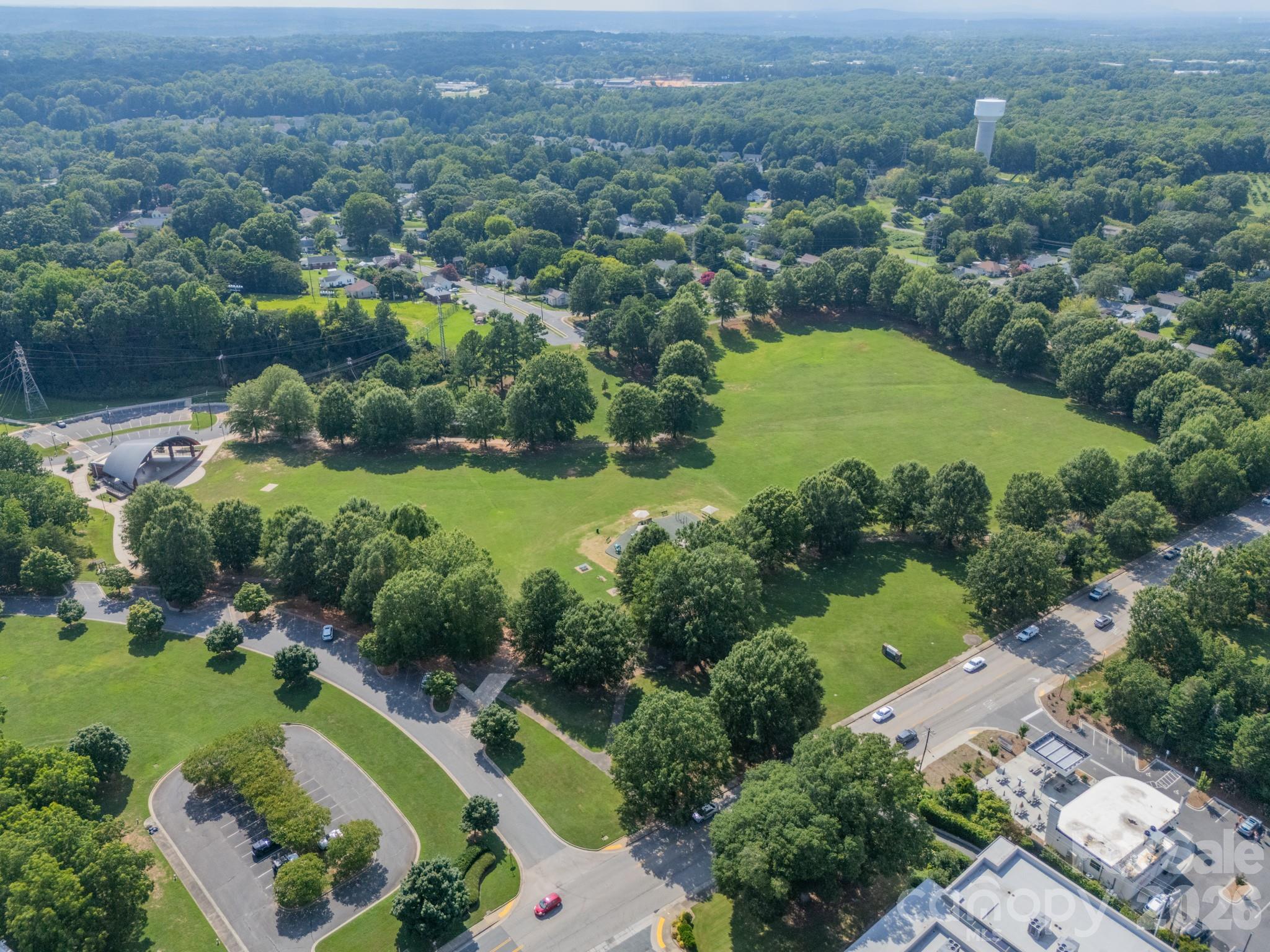 204 West Elliott Street Fort Mill, SC 29715 - Photo 42 of 43 an aerial view of green landscape with trees houses and mountain view