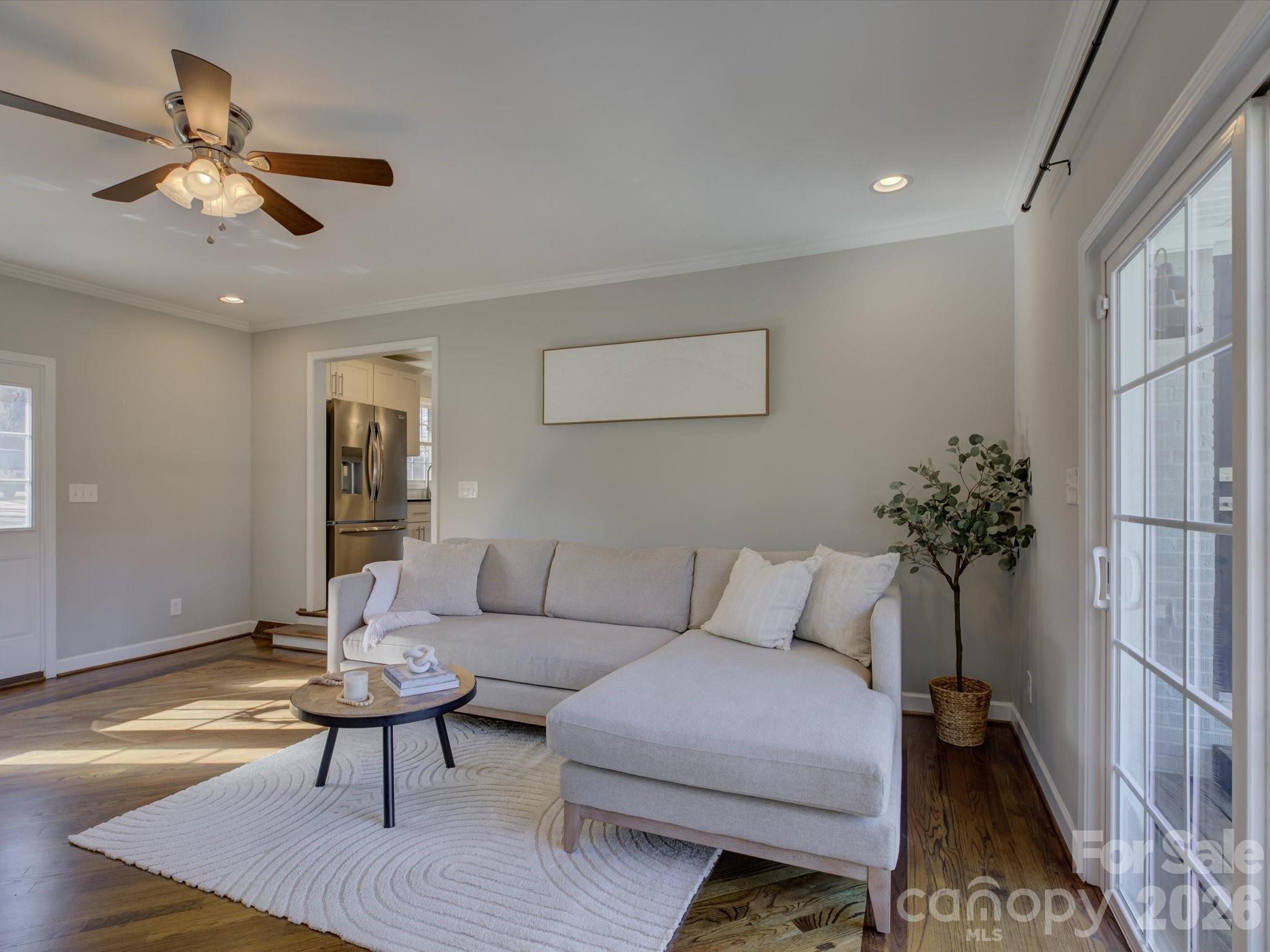 204 West Elliott Street Fort Mill, SC 29715 - Photo 8 of 43 a living room with furniture and a chandelier