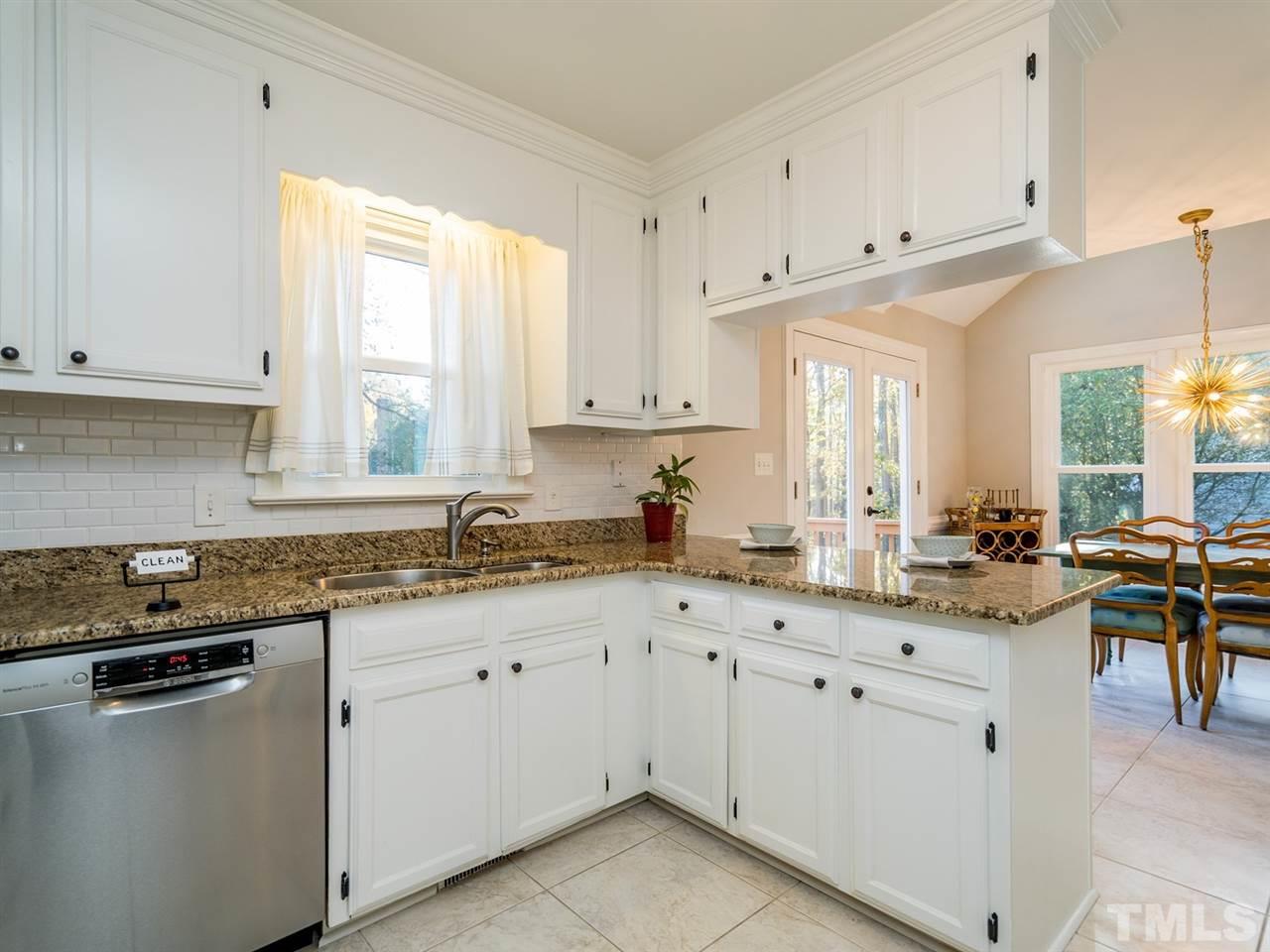 8508 Council Court Raleigh, NC 27615 - Photo 13 of 27 The kitchen is partially open to the dining room for ease in serving your guests.