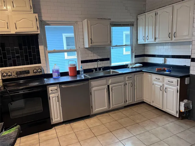 a kitchen with stainless steel appliances granite countertop a sink stove and cabinets