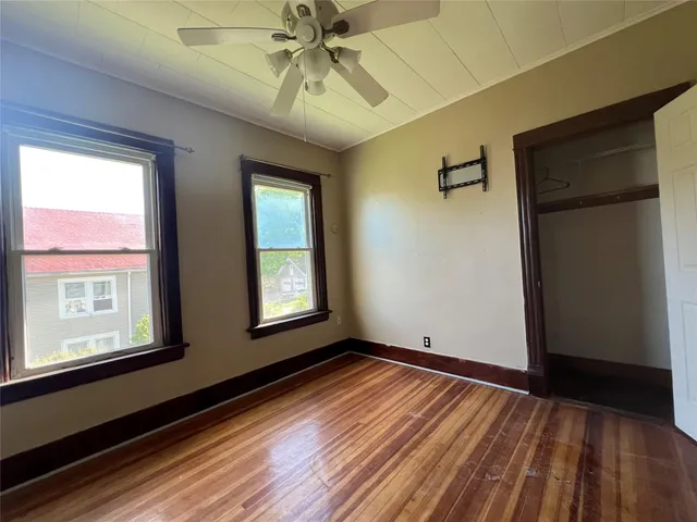 wooden floor in an empty room with a window