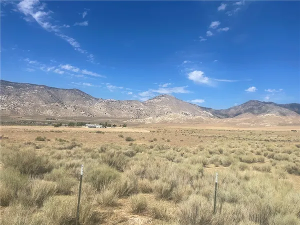 a view of a large mountain with mountains in the background
