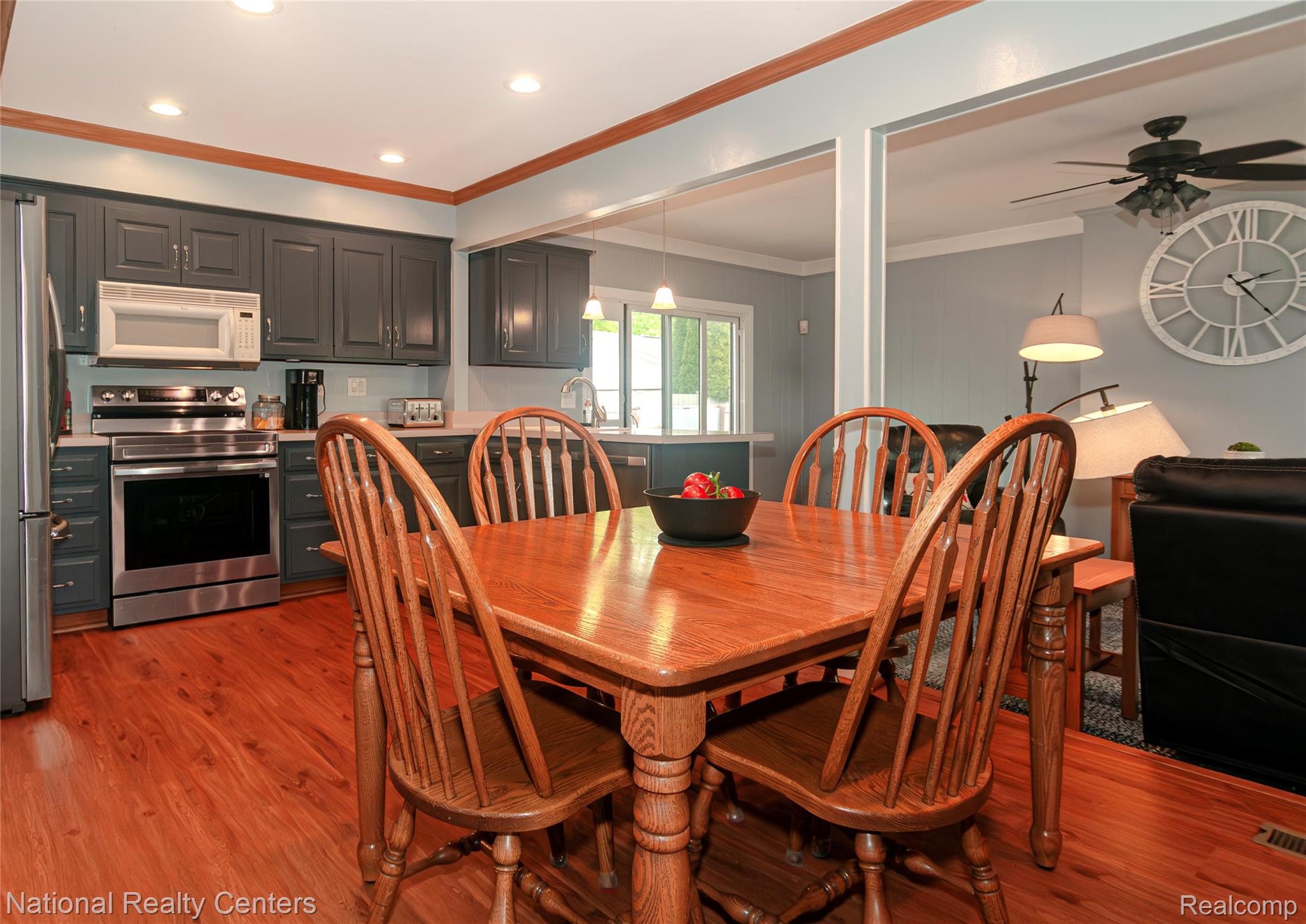 2446 Milverton Road Troy, MI 48083 - Photo 9 of 41 Dining space with crown molding, dark wood-style flooring, a ceiling fan, and recessed lighting