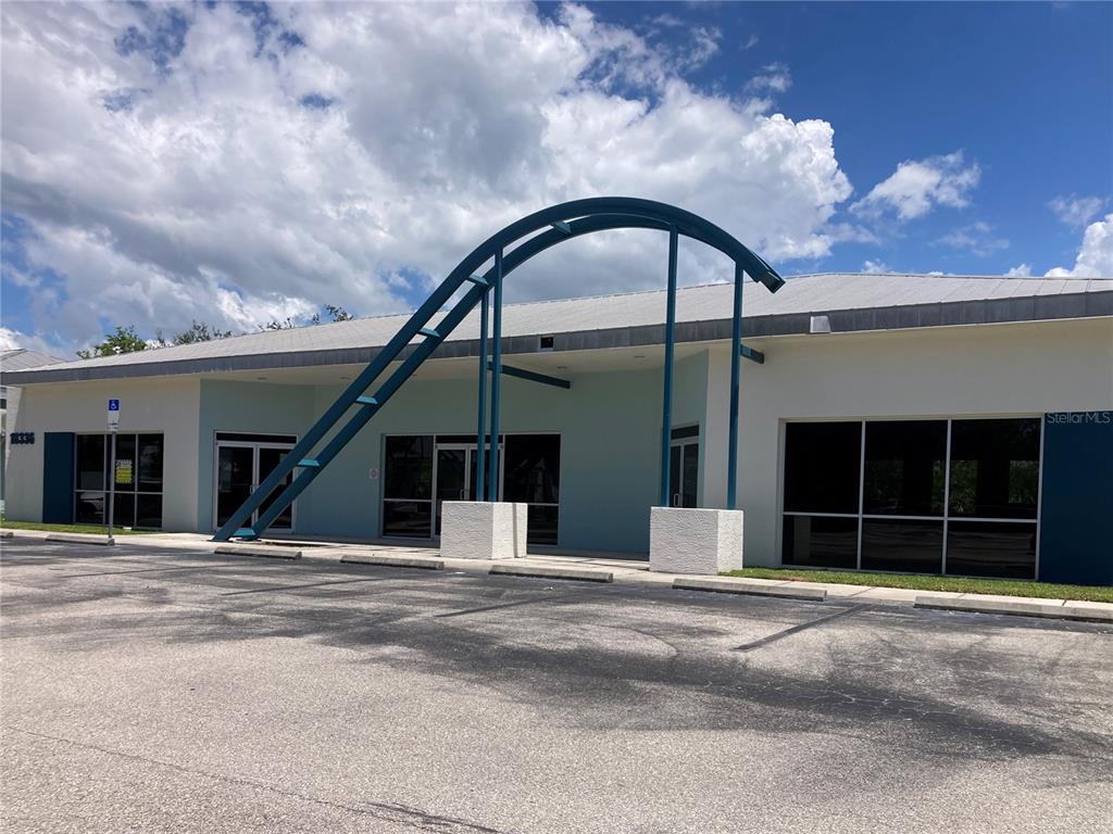 18340 Murdock Circle Port Charlotte, FL 33948 - Photo 4 of 9 a view of a house with a yard and potted plants
