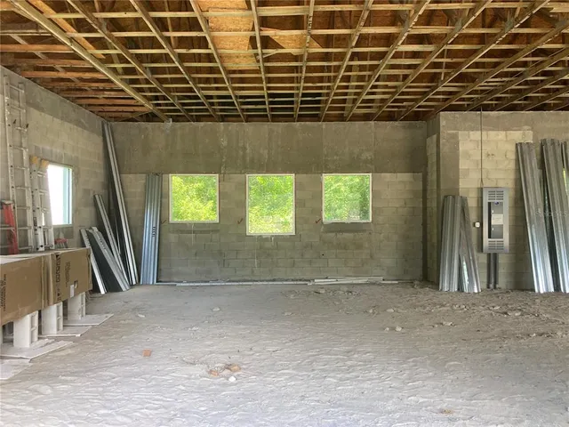 a room with pool table and windows