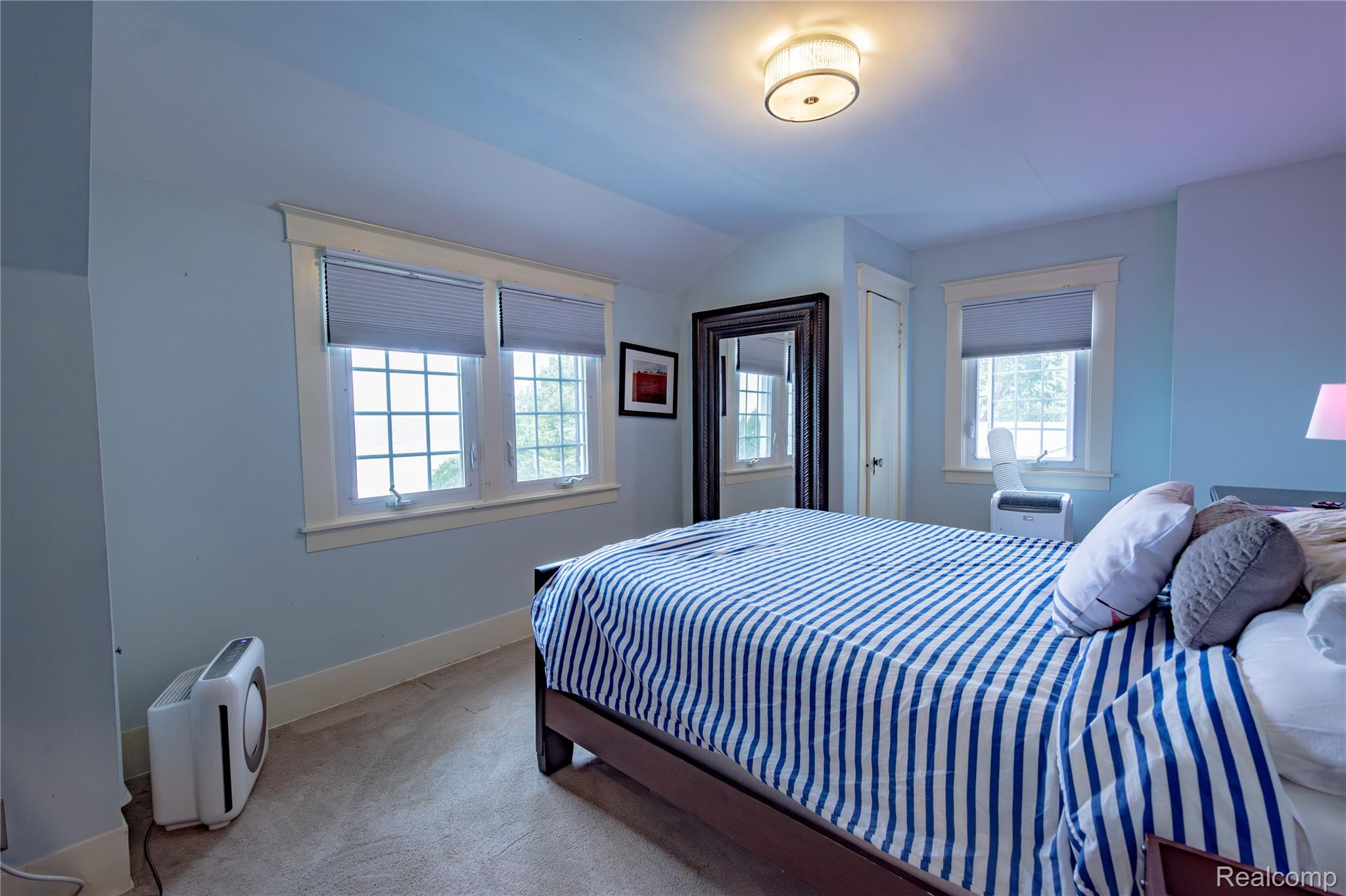 5630 Lakeshore Road Fort Gratiot, MI 48059 - Photo 32 of 49 Light-filled room featuring multiple windows with grid patterns, neutral carpet, white trim, and a flush-mount ceiling light fixture