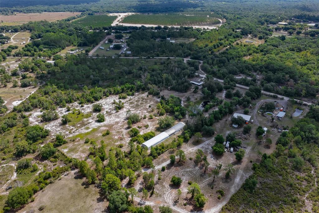 14451 Highland Road Wimauma, FL 33598 - Photo 77 of 80 an aerial view of residential houses with outdoor space and trees
