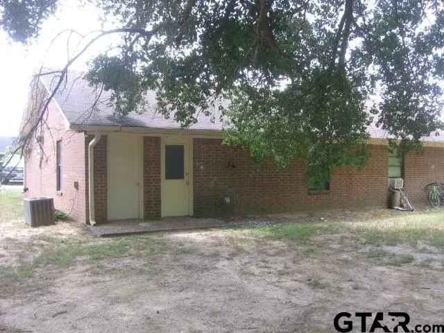 a house that has a tree in front of it