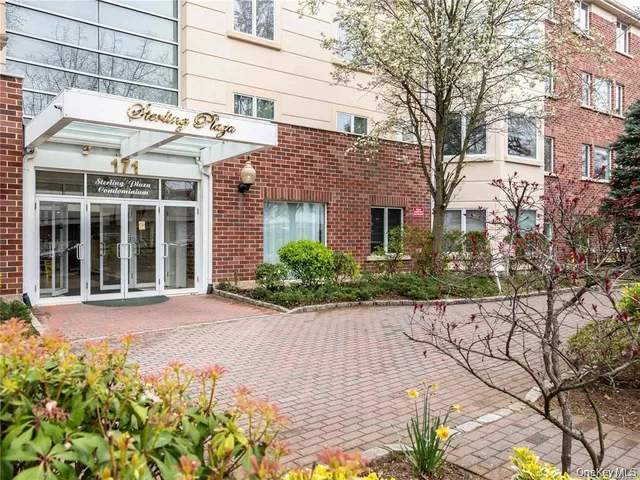 a front view of a building with a garden